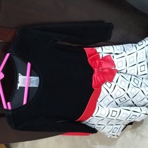 It's like a black dress with like gold and black on the bottom with the red bow